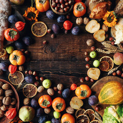 Fototapeta na wymiar Autumn still-life composition with fresh fruits and vegetables on rustic wooden table