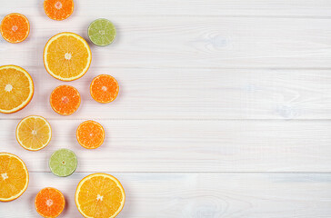 Citruses on white wooden background