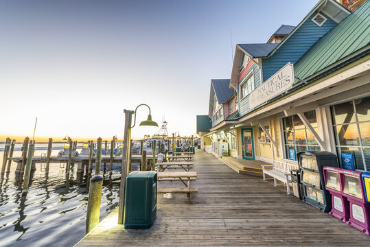 DESTIN, FLORIDA - FEBRUARY 2016: Destin Harbor Boardwalk At Sunset With Shops And Ocean