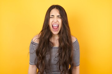 Stressful hipster woman screams in panic, closes eyes in terror, keeps hands on head, finds out...