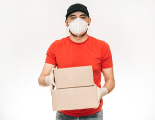 Fototapeta na wymiar man courier delivers order in boxes, , in medical surgical mask, gloves, in quarantine. Coronavirus, isolation, safe, stay at home, online shopping.
