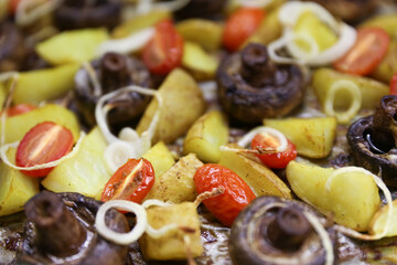 baked mushrooms champignons with potatoes and tomatoes