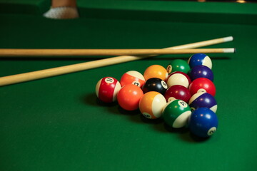 billiard background with color balls and cues on green table