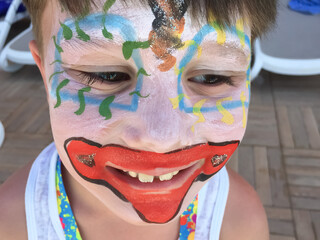 Child laughing, face painting, close-up face