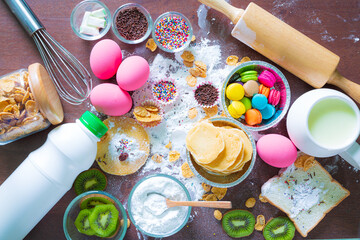 bowls of ingredients needed for baking colorful cupcakes