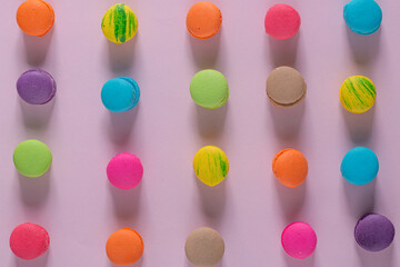 Dessert cake macaron or macaroon on pink background top view. Flat lay composition.