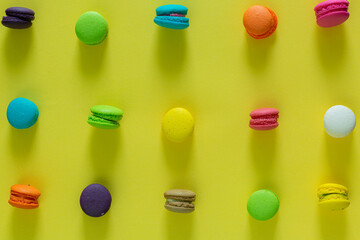 Sweet and colorful french macaroons or macaroon on yellow background, Dessert eating with tea or...