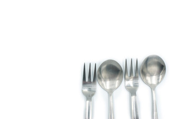 Spoons and forks on a white background