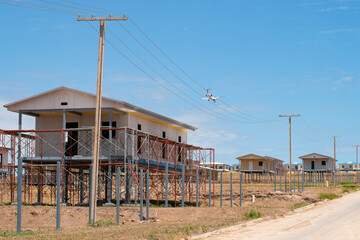 Papua New Guinea, Port Moresby, 7 Mile Kennedy Estate. Chinese builders continue construction of houses for local community. 