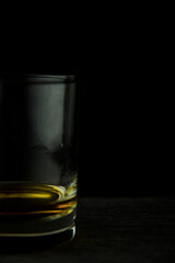 Glass of whiskey on a black background close up