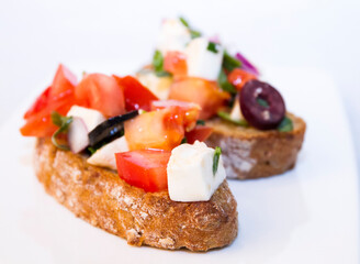 Italian bruschetta with tomatoes, feta, onions and olives