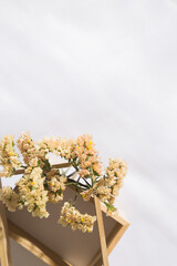 Top view of a wooden niche in voile fabric background with flowers, with space for text. Vertical
