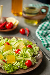 On the table are salad, tomatoes and garlic.
