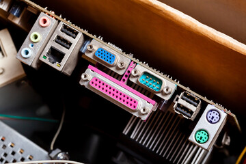 Old dated motherboard back side closeup, ports input/output, VGA, parallel, PS/2. Obsolete pc...