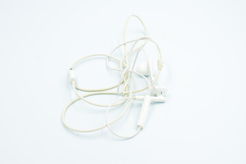 Headphone cable tangled on a white background