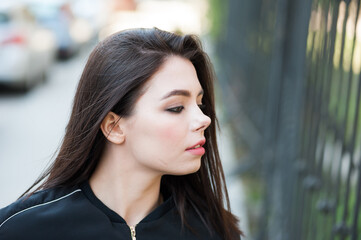 Young beautiful modern woman outdoors with expressive makeup