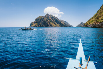El Nido, Philippines. Front of Island hopping Tour boat hover over open strait between exotic karst...