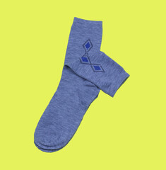Grey men's socks on a yellow background