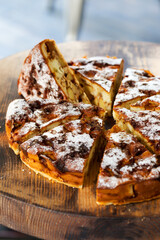 Authentic sponge cake with raisins, cinnamon and apples. Morning atmospheric lighting, fashionable trendy spot soft focus. Preparation for design creative menu. Culinary pastries.
