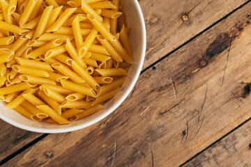 Ingredients for a pasta salad on an old wooden table