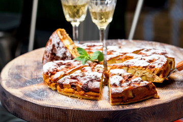 Authentic sponge cake with raisins, cinnamon and apples. Morning atmospheric lighting, fashionable trendy spot soft focus. Preparation for design creative menu. Culinary pastries.