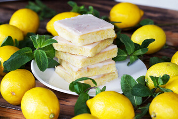 Authentic Shortcake Cake, a lot of fresh yellow lemons and mint. Morning atmospheric lighting, fashionable trendy spot soft focus. Preparation for design creative menu.
