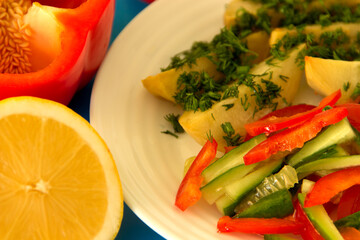Potatoes with vegetables on a white plate. Close-up..