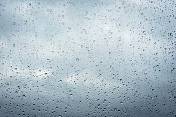 Raindrops on window glass surface, background texture