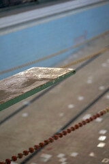 Detail of dirty vintage diving board in abandoned imperial times swimming bath       