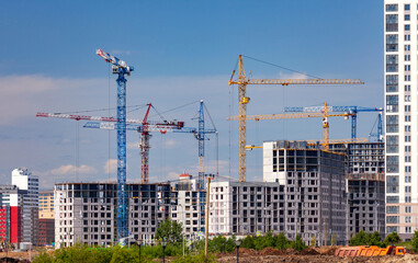 Construction site.  Many of cranes in work