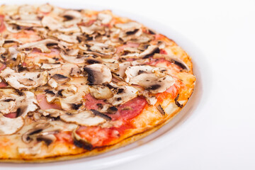 Pizza with salami and mushrooms on a white background up close