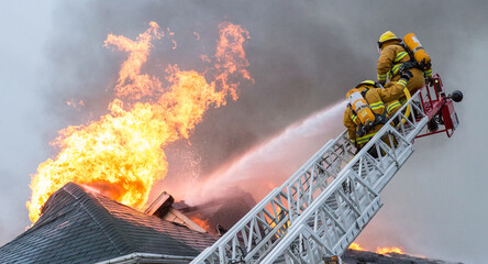 Firefighters battle blazing house fire.
