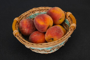 Peach heap in the wooden basket