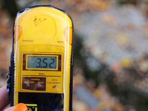 A dosimeter is held showing 3.52 millisieverts near a "hot spot" in the Chernobyl exclusion zone, Ukraine. This amount of radiation is slightly less than that of a dental x-ray.