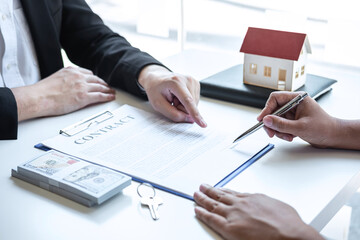 Estate agent broker pointing contract form to client signing agreement contract real estate with approved mortgage application form, buying or concerning mortgage loan offer for and house insurance