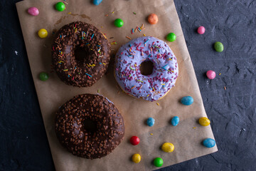 Donuts on a wooden board on a blue concrete background