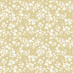 Vintage floral background. Seamless vector pattern for design and fashion prints. Flowers pattern with small white flowers on a ivory background. Ditsy style.