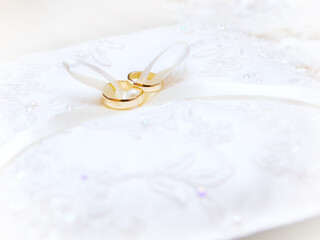 Wedding rings on a pillow for your invitation card