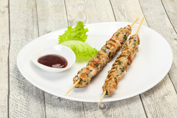 Minced pork skewer kebab with sauce