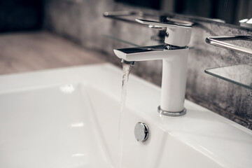 White faucet with bathroom, close-up. Hygiene and cleanliness.