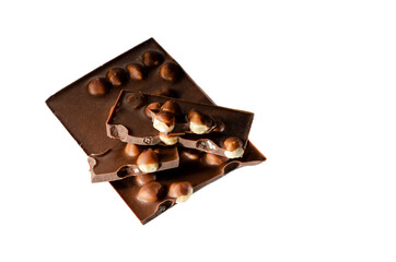 Appetizing milk chocolate with whole hazelnuts on a white background