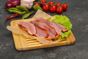 Sliced smoked duck breast served salad