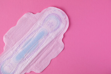 Menstrual pad with red glitter on pastel colored background. Minimalist still life photography concept, pms