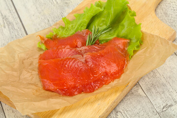 Sliced salmon fillet served rosemary