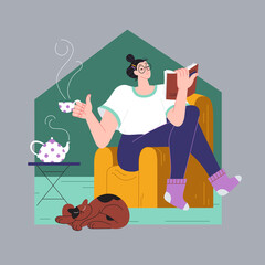 Woman reads a book on an armchair and drinks tea.