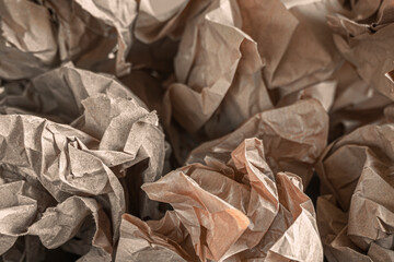 Crumpled craft paper closeup shot. Lumps of brown paper.