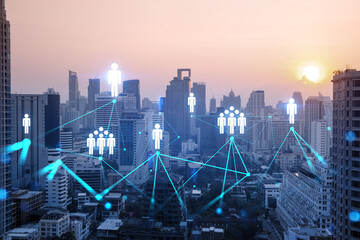 Hologram of social media icons over sunset panoramic cityscape of Bangkok, Asia. The concept of people connections. Multi exposure.
