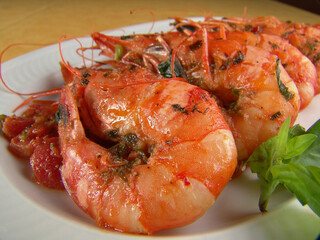 Shrimps in a salad on a white dish.