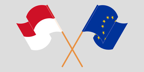 Crossed and waving flags of Indonesia and the EU