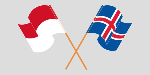 Crossed and waving flags of Indonesia and Iceland